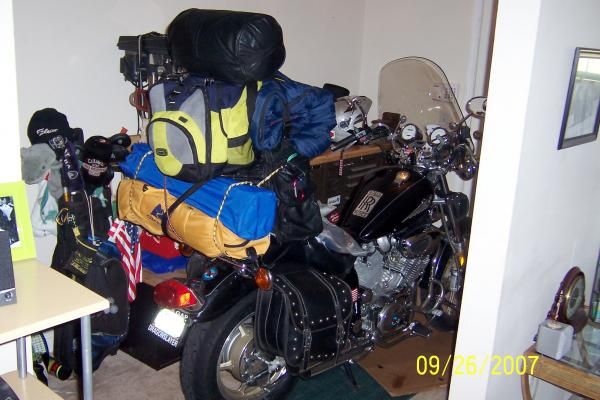 Is this a bachelor pad or what... motorcycle, toolbox, golf clubs, and tennis rackets - in the foyer