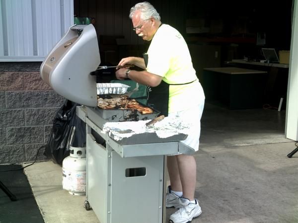 Ken Bodnar slaving over a hot grill. Hots and chicken Mmmmm!